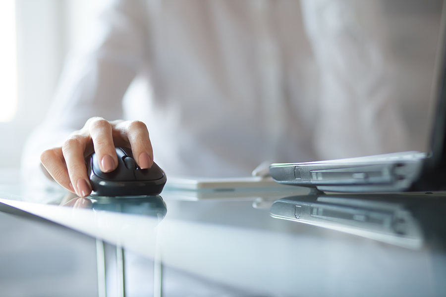 Closeup of woman using a computer mouse. 