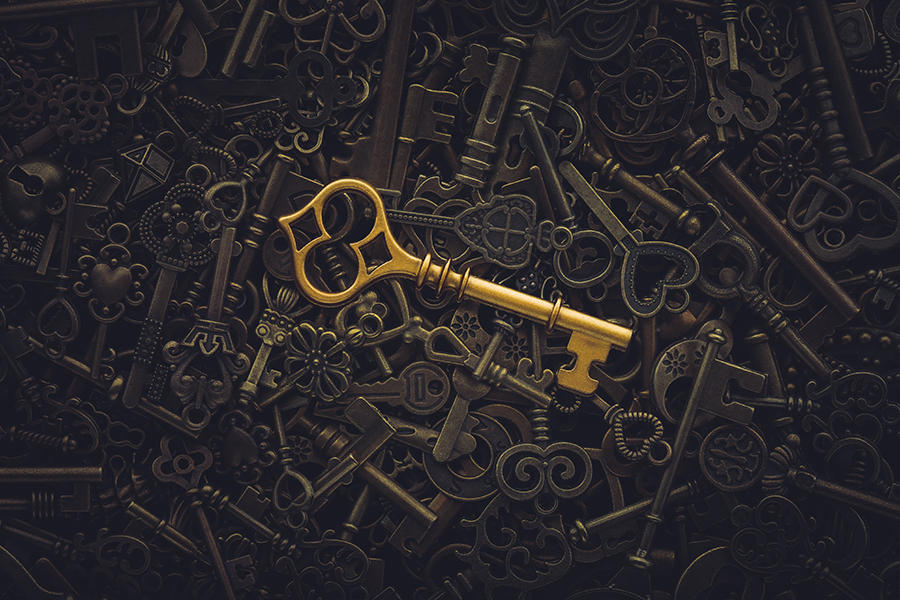 An elegant key standing out in a pile of keys symbolizing the right solution out of hundreds of possible solutions.